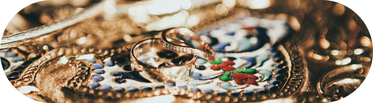 Gold rings on ornate jewelry